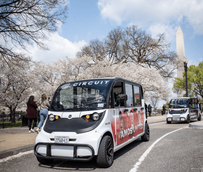 Circuit vehicle in front of Washington, DC cherry blossons and the Washington Monument