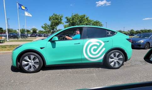 Circuit Driver Smiling from Circuit Branded Tesla